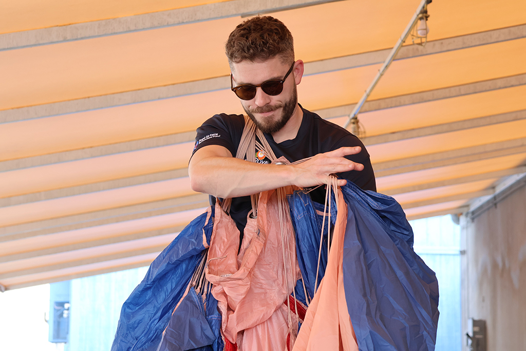 Corporal Edmund Dyson prepares a parachute for packing